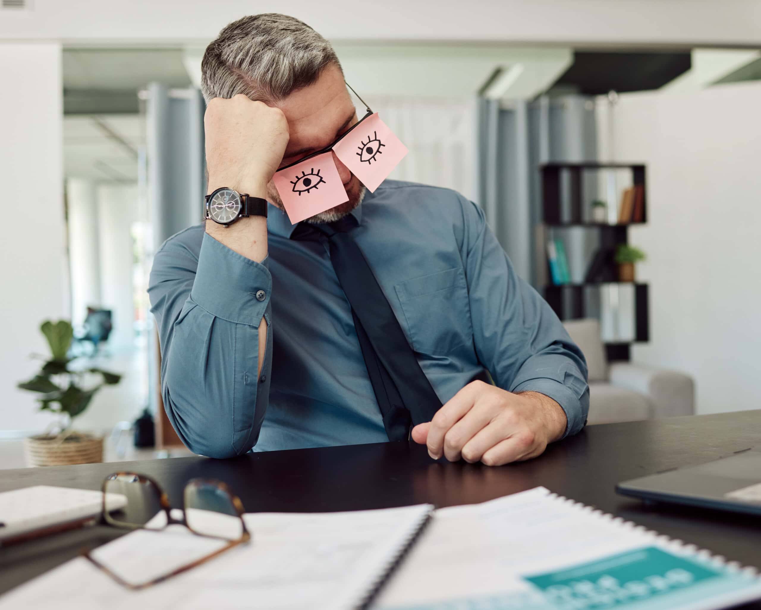 tired, sticky notes and businessman sleeping in his office with a burnout, exhaustion or overworked. overtime, rest and professional mature male lawyer taking nap on his lunch break in the workplace.